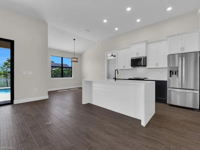 Unfurnished living room with a ceiling fan, wood tiled floors, and recessed lighting