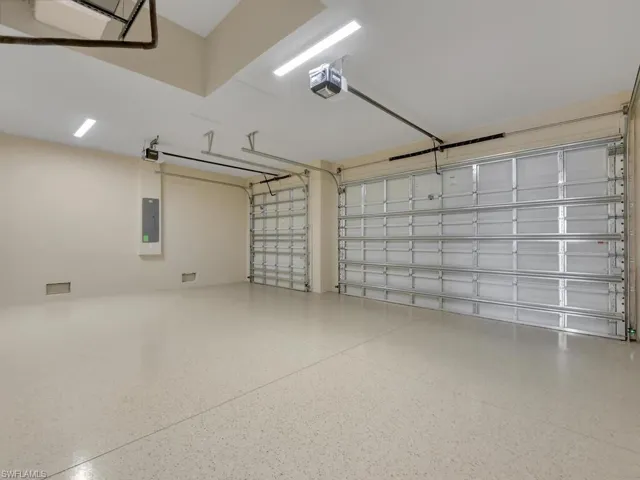 Unfurnished bedroom featuring wood tiled floors, ceiling fan, and two closets