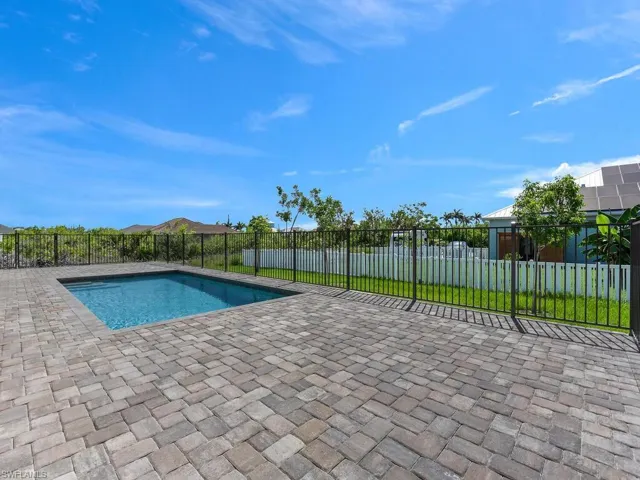 Fenced backyard featuring a patio area and a residential view