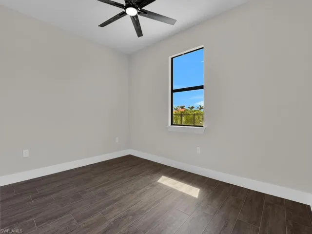 Spare room with wood finish floors and ceiling fan