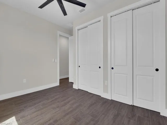 Bedroom featuring wood finish floors and a ceiling fan