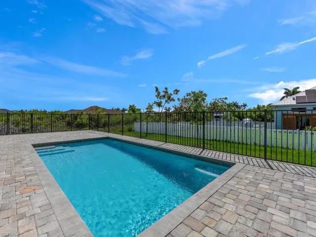 Fenced backyard with a patio