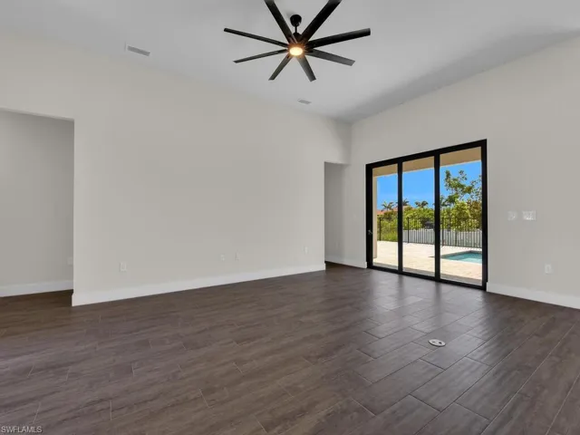 Unfurnished living room featuring a ceiling fan, french doors, wood finish floors, and recessed lighting