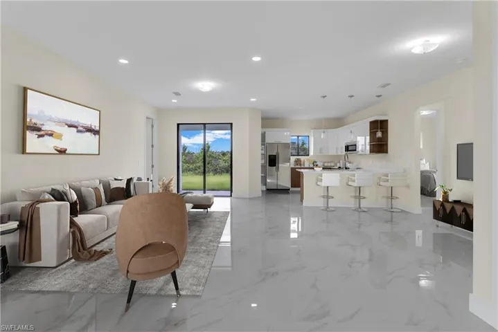 Living room with light marble finish flooring and recessed lighting