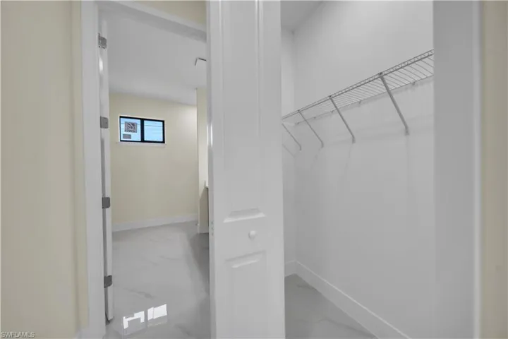 Spacious closet featuring marble look tiles