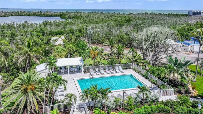 Community pool featuring a patio area and a water view