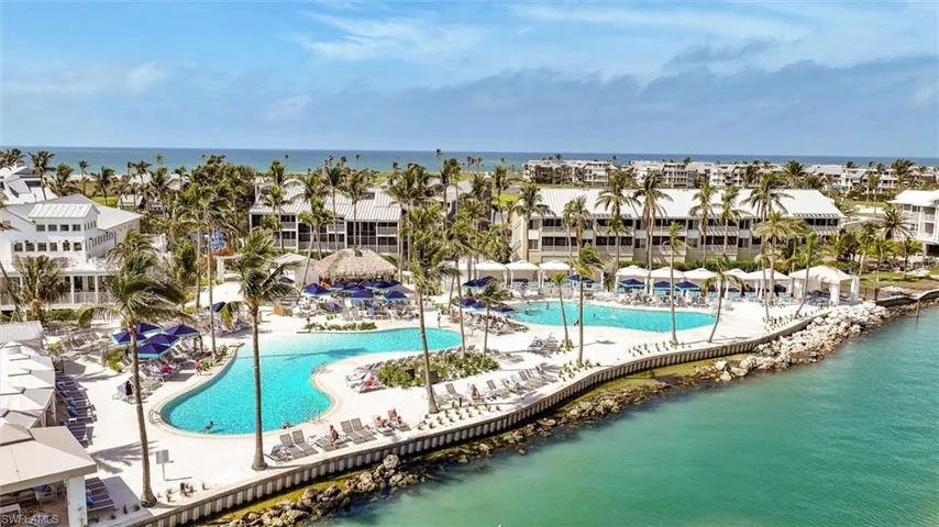 Community pool with a water view and a patio area