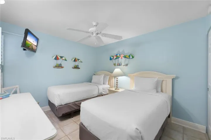 Bedroom with a ceiling fan and light tile patterned floors