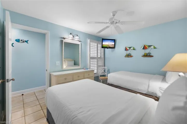 Bedroom featuring light tile patterned flooring and ceiling fan