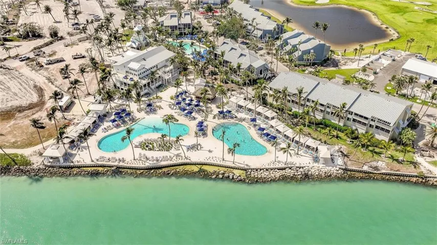 Bird's eye view of a pool area and a large body of water