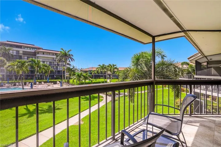 Balcony featuring view of pool area