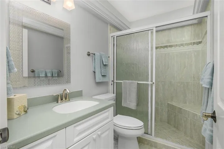 Bathroom with a shower stall and vanity
