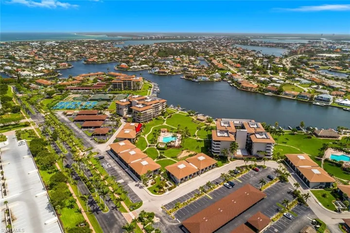 Aerial view of residential area featuring a large body of water