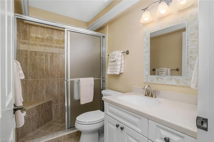 Bathroom featuring vanity and a shower stall