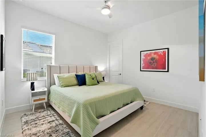 Bedroom featuring a ceiling fan and light wood-type flooring