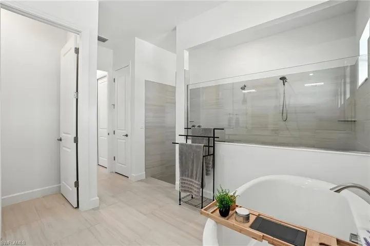 Full bath featuring a stall shower and a freestanding bath