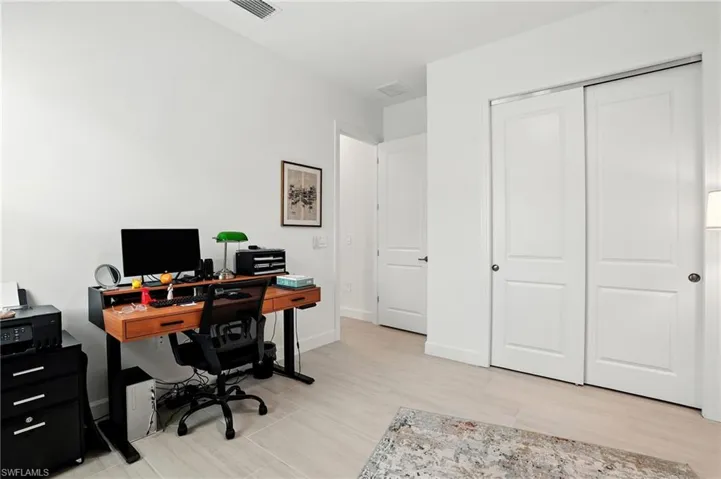 Office area with light wood-type flooring and baseboards