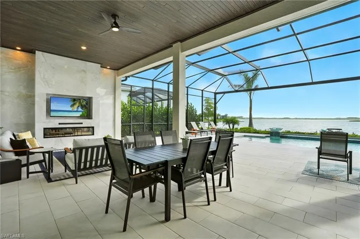 View of patio featuring a sunroom, a lanai, an outdoor hangout area, outdoor dining space, and an outdoor pool