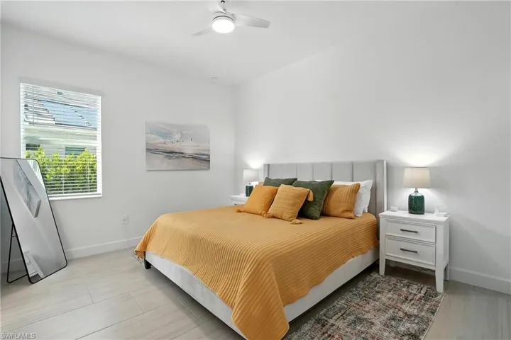Bedroom featuring ceiling fan and baseboards