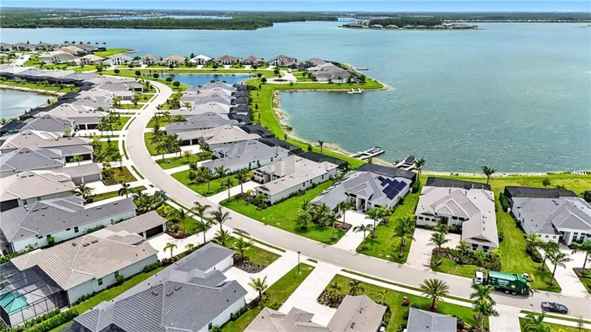 Aerial perspective of suburban area featuring a large body of water