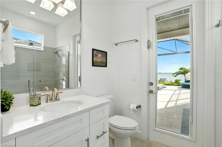 Bathroom with vanity, a stall shower, and a water view
