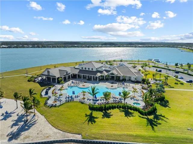 Drone / aerial view of a pool and a large body of water