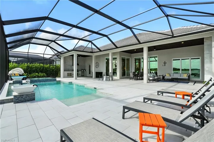 Swimming pool with a sunroom, a ceiling fan, and a patio area