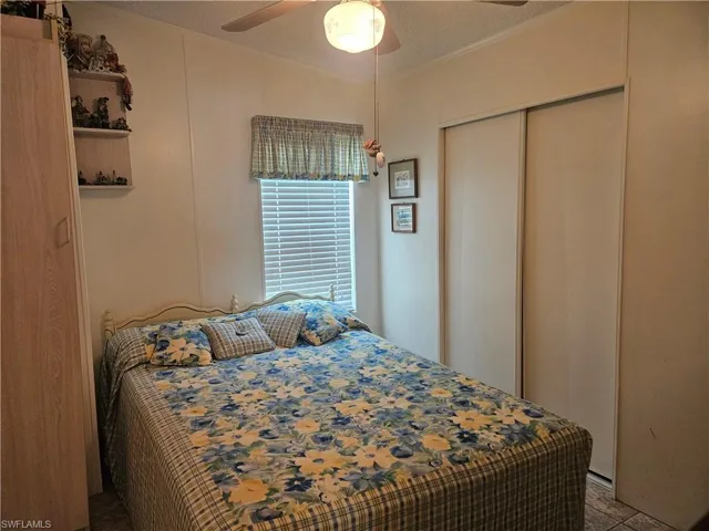 Bedroom with crown molding, a closet, and ceiling fan