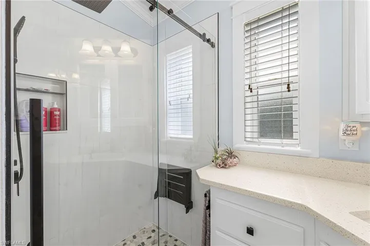 Bathroom featuring a shower stall and vanity