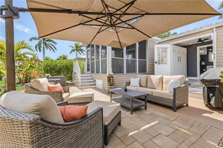 View of patio / terrace with outdoor lounge area, a sunroom, and area for grilling