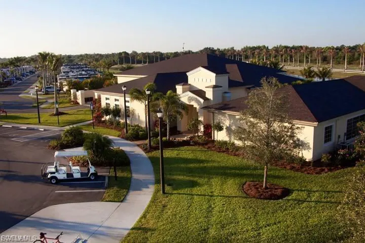 Mediterranean / spanish house with a front yard, uncovered parking, and stucco siding