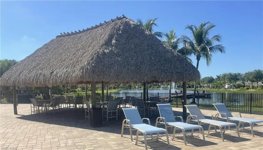 View of community with a patio area, a gazebo, a water view, and outdoor dining space
