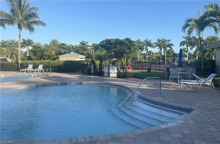 Community pool with a patio