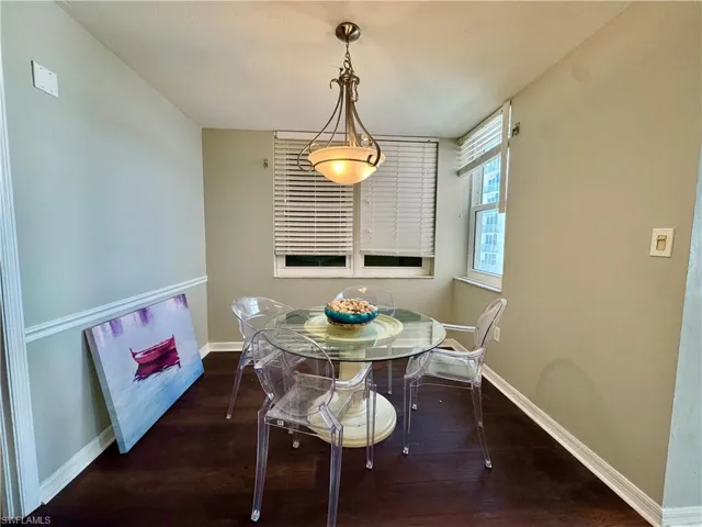 Dining space with baseboards and wood finished floors