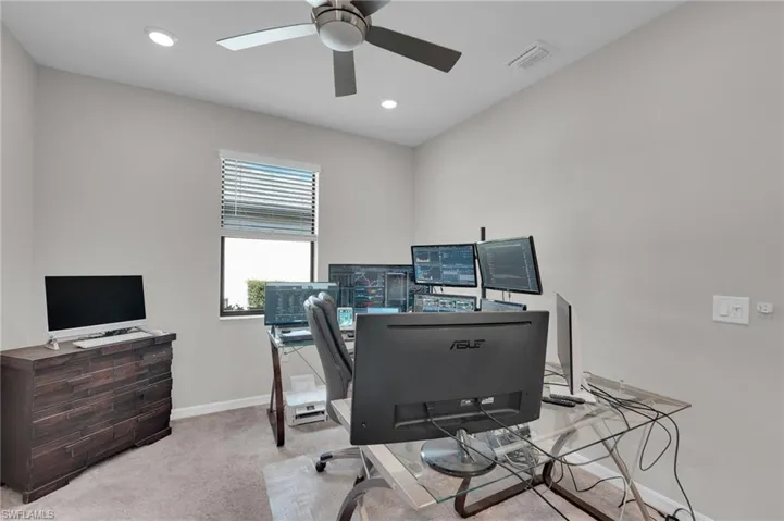 Office area with light carpet and recessed lighting