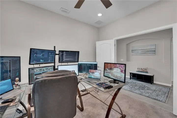 Home office featuring recessed lighting and a ceiling fan