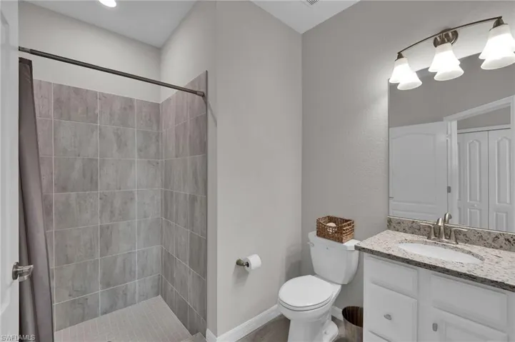 Bathroom featuring vanity, connected bathroom, and a ceiling fan