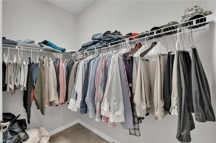 Walk in closet with light tile patterned floors
