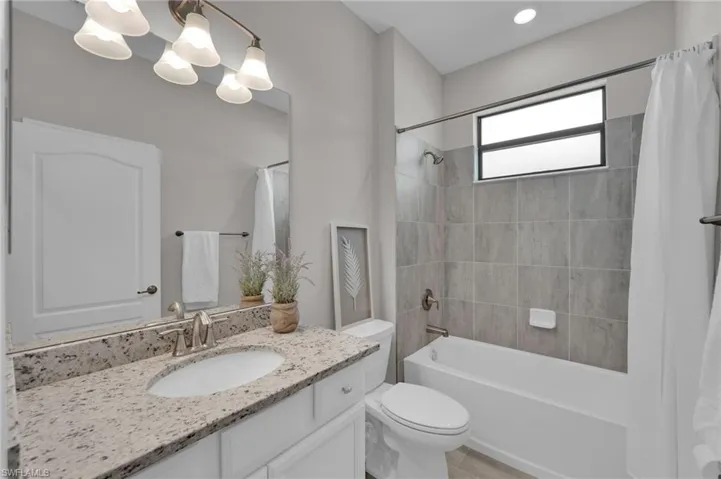 Walk in closet with light tile patterned floors