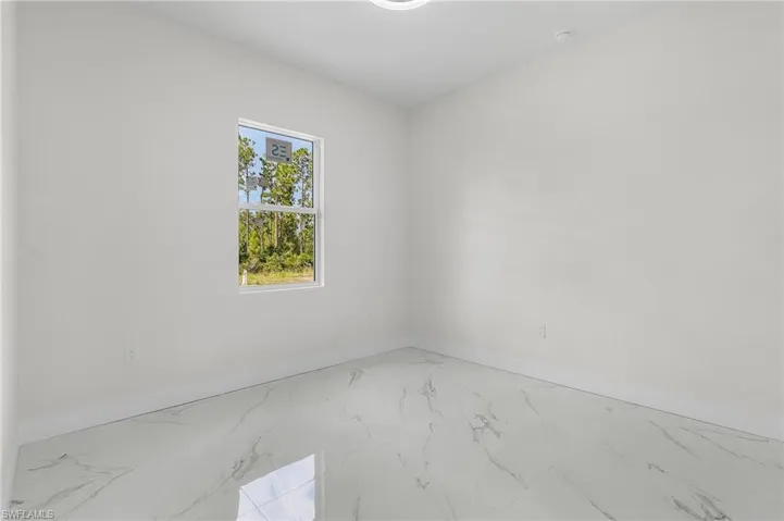 Empty room featuring light tile patterned flooring