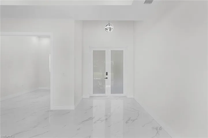 Spare room with tile patterned flooring