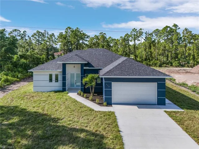 Ranch-style home with a garage and a front yard