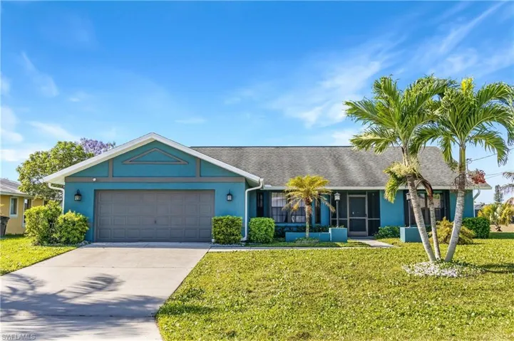 Ranch-style home featuring a front yard, a sunroom, concrete driveway, stucco siding, and an attached garage