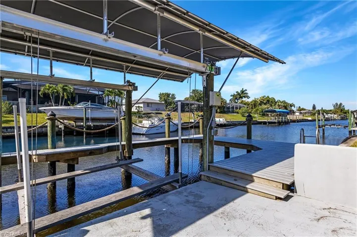 Dock with boat lift and a water view