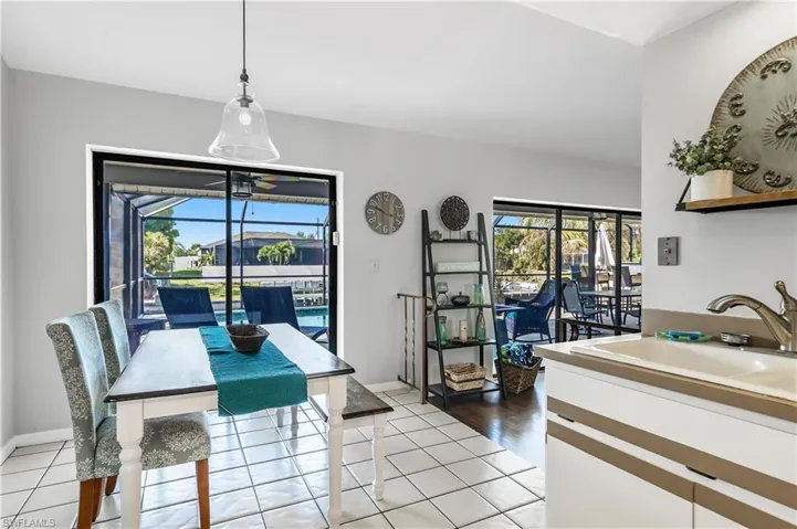 Dining area with a sunroom and light tile patterned flooring