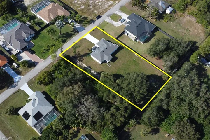 Aerial perspective of suburban area featuring property boundaries highlighted