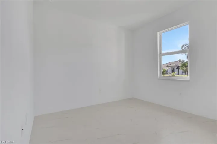 Guest bedroom 1 featuring light marble finish floors