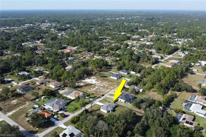 Aerial overview of property's location with nearby suburban area
