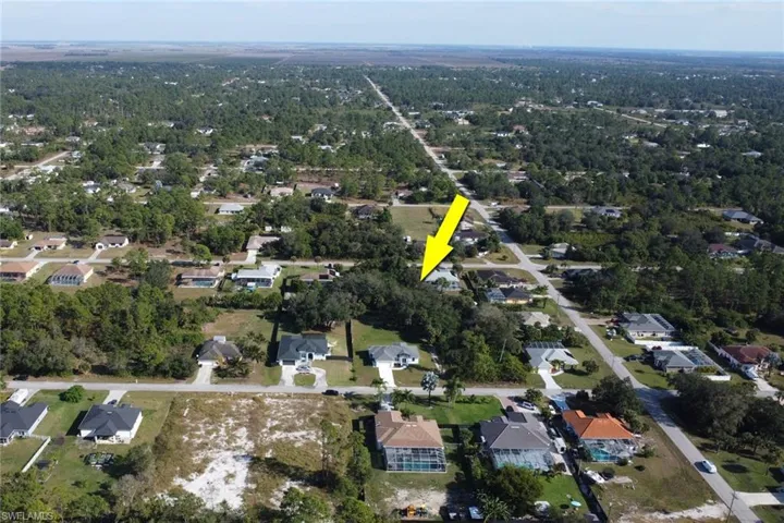 Aerial view of property's location with nearby suburban area