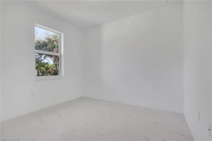 Guest bedroom 2 with baseboards and light marble finish floors